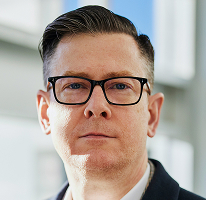 Portrait of Alexander Hughes, executive CEO of a crypto trading company